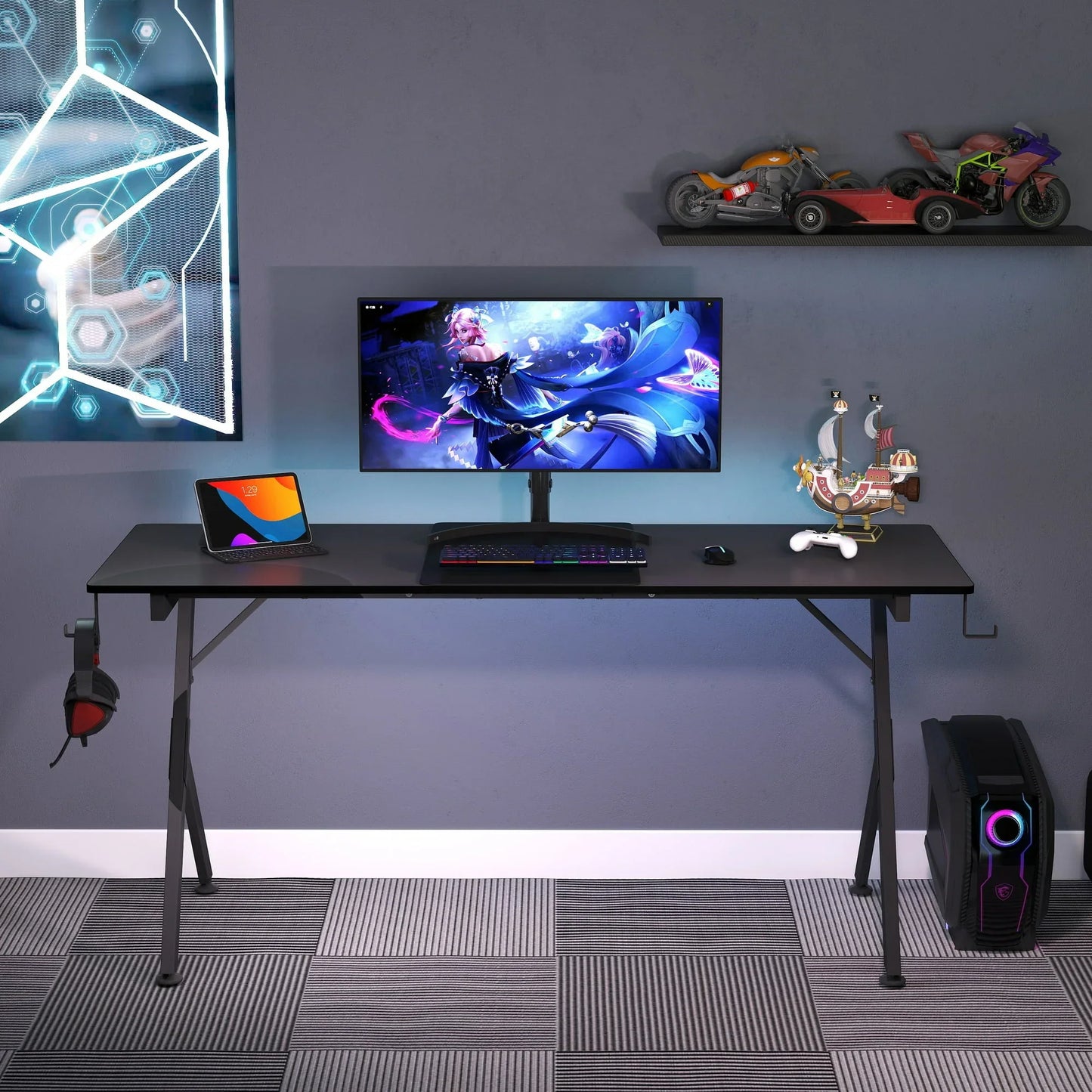 Modern gaming setup with ultrawide monitor displaying fantasy game, mechanical keyboard, tablet, and desktop PC
