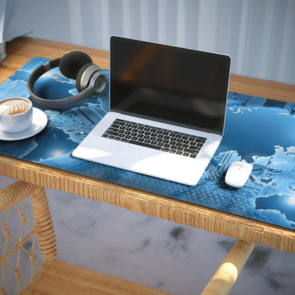 Wooden desk with laptop, wireless headphones, white mouse, and cup of coffee on a blue tech-themed mousepad