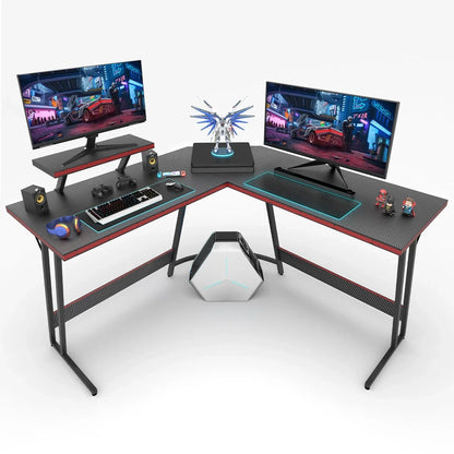 L-shaped carbon fiber gaming desk with dual monitors, keyboard, gaming controller, headphones, and desktop PC