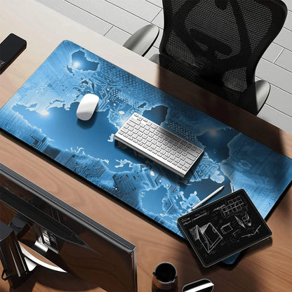 Modern desk setup with black mesh chair, blue world map tech design mouse pad, wireless keyboard, mouse, and tablet