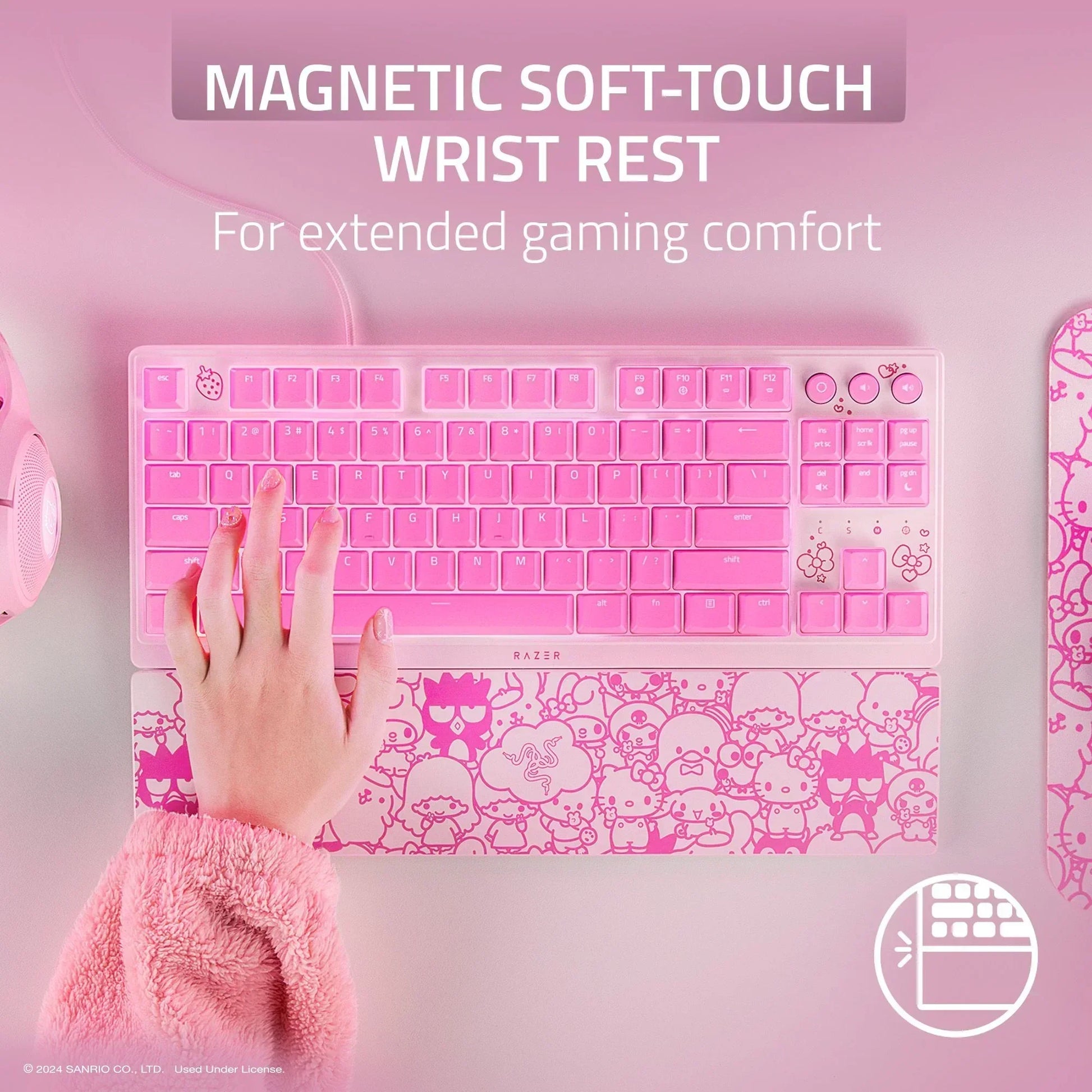 Pink Razer gaming keyboard with magnetic soft-touch wrist rest, Hello Kitty design, desktop setup.