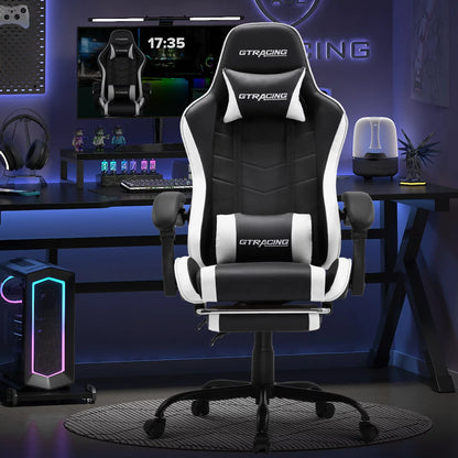 Black and white GT Racing ergonomic gaming chair in a modern blue-lit gaming setup with monitor and PC