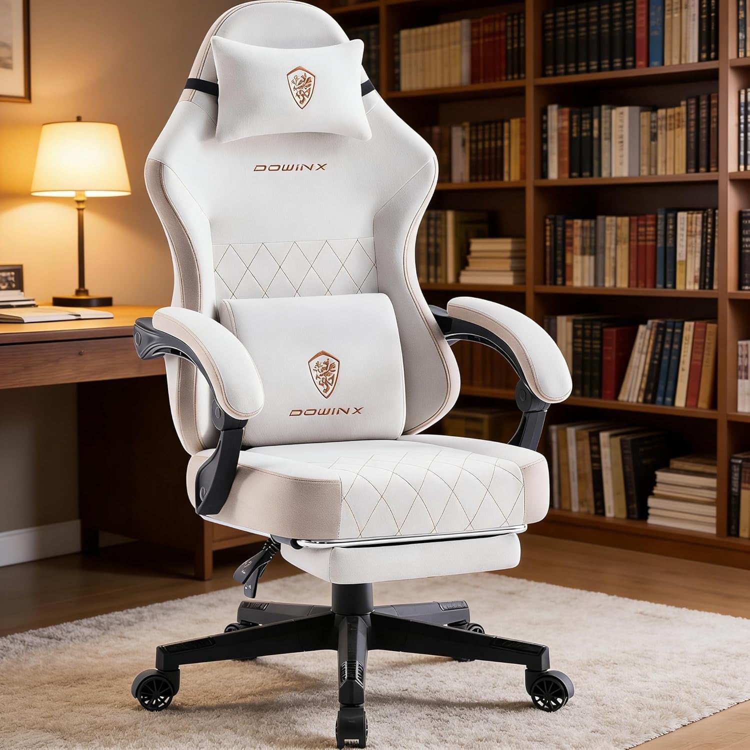 White DOWINX gaming chair with lumbar & neck pillows, quilted design, in home office with bookshelves