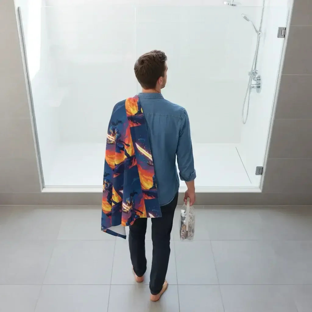 Man in blue shirt with galaxy print towel enters modern glass shower, holding toiletry bag
