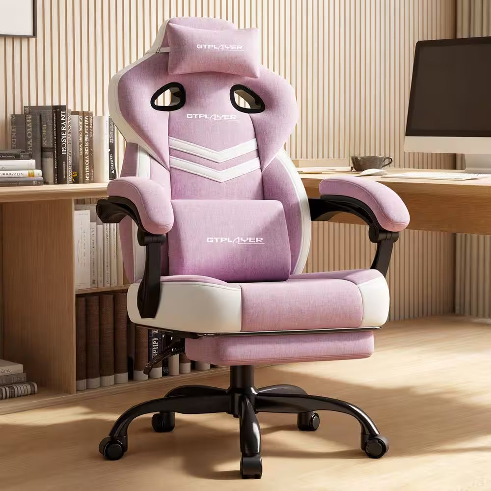 Pink GTPLAYER gaming chair with lumbar pillow, headrest, and footrest in modern desk setup