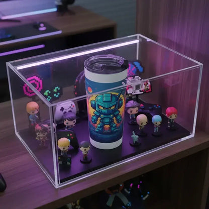 Clear display case with gaming-themed tumbler and mini collectible figurines inside on wooden desk