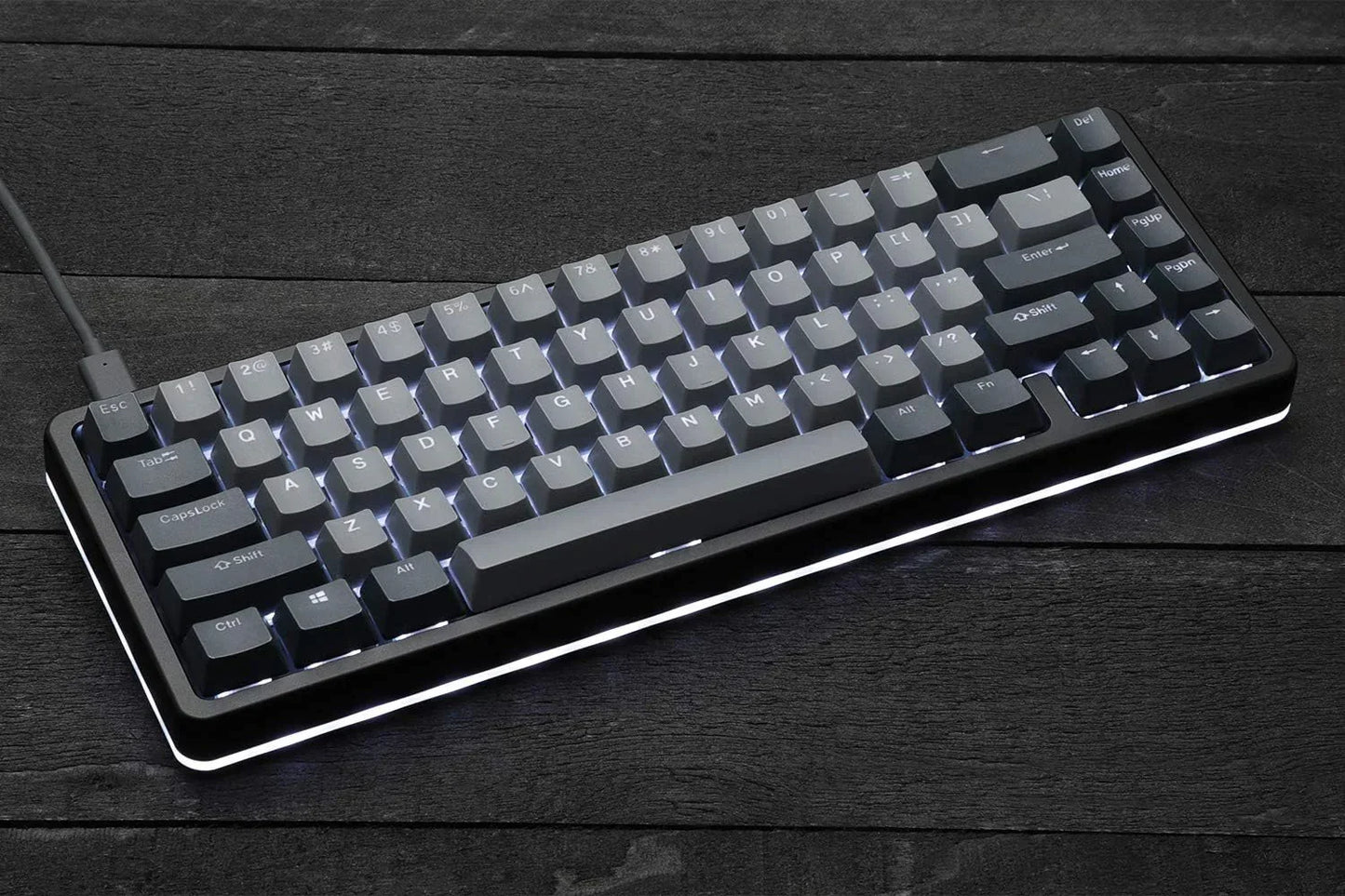 RGB-backlit mechanical gaming keyboard on dark wood desk, retro 8-bit Byte Style gear