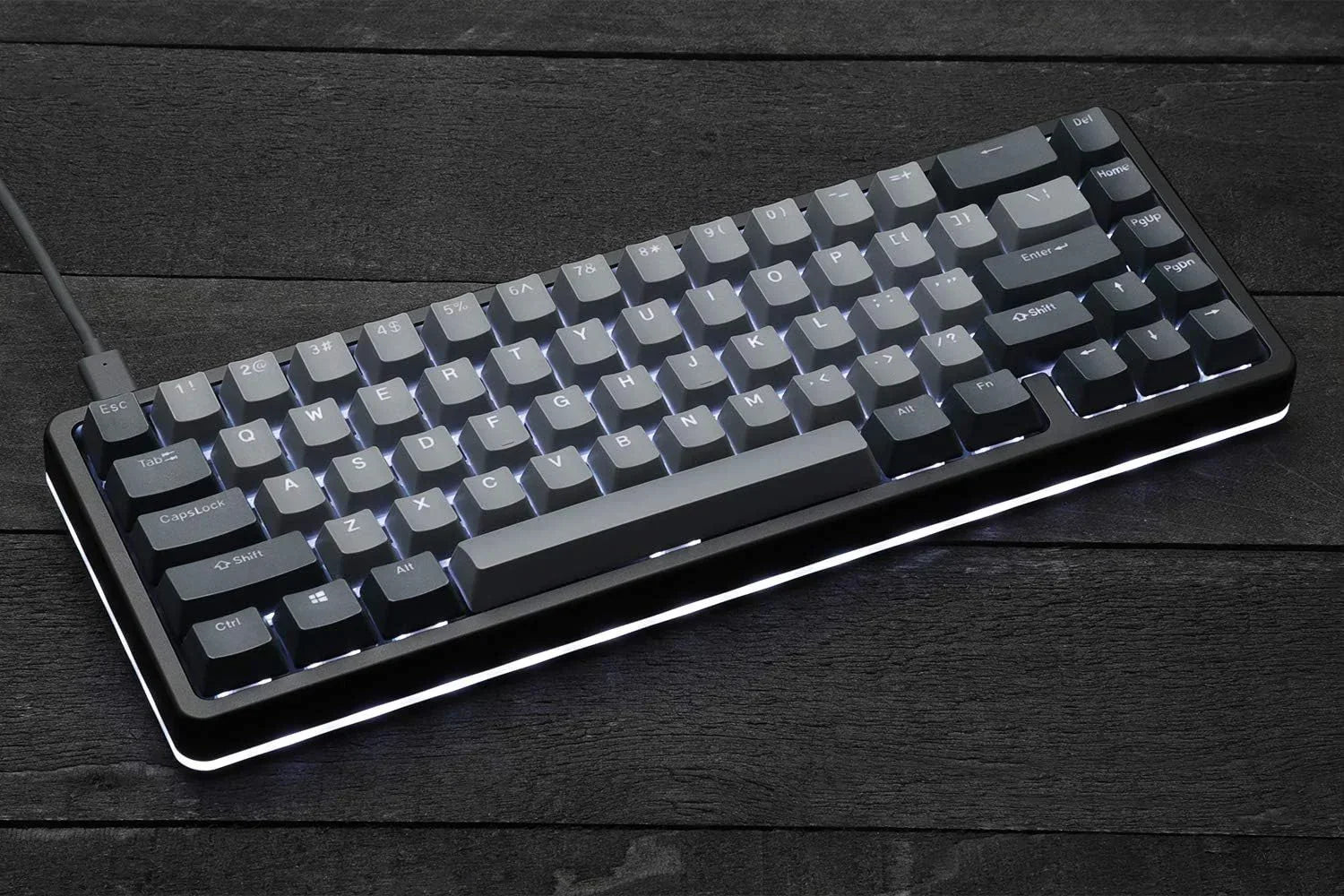 RGB-backlit mechanical gaming keyboard on dark wood desk, retro 8-bit Byte Style gear