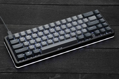 RGB-backlit mechanical gaming keyboard on dark wood desk, retro 8-bit Byte Style gear
