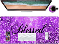 Purple glitter gaming desk mat with 'Blessed' text, white keyboard, mouse, smartphone, and coffee cup