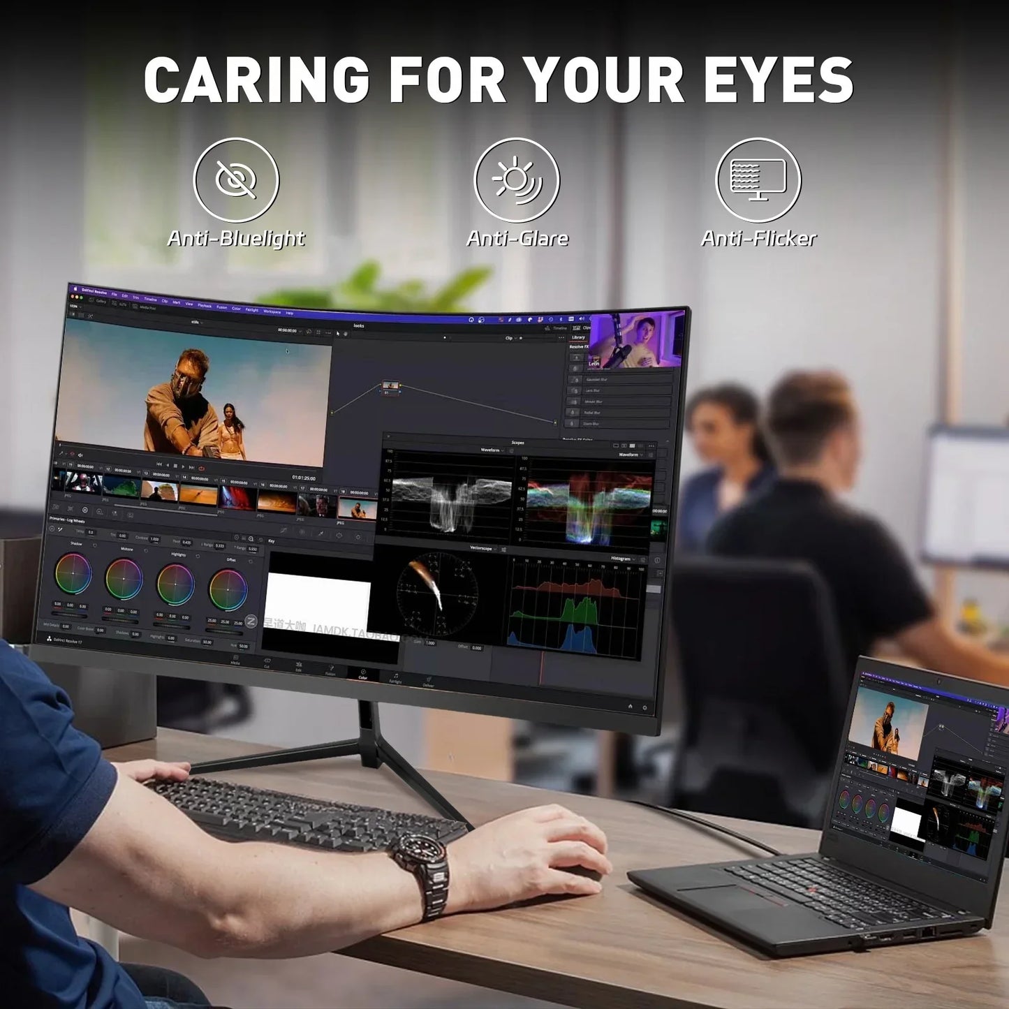 Curved desktop monitor with video editing software displaying color grading and scopes, connected to laptop on office desk