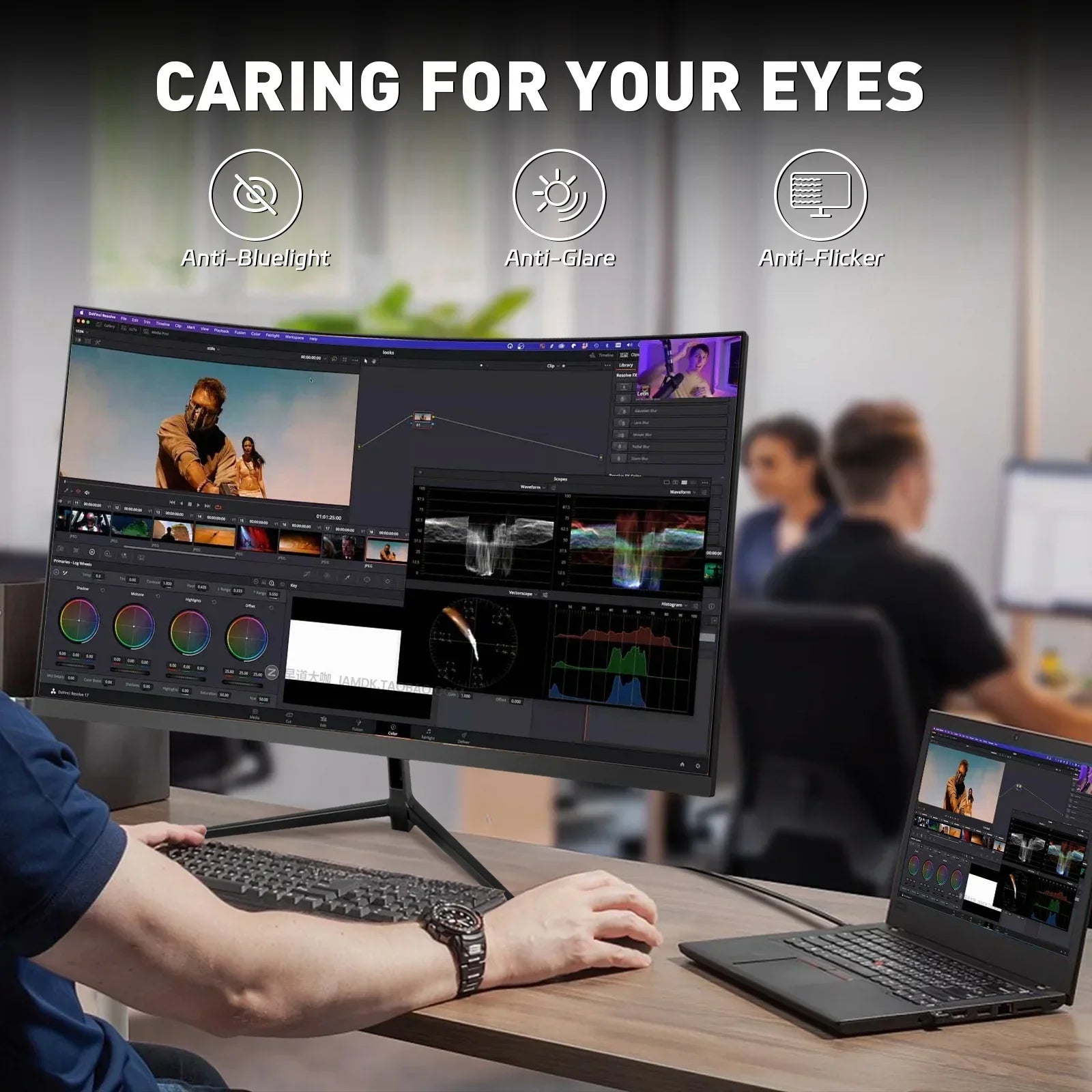 Curved desktop monitor with video editing software displaying color grading and scopes, connected to laptop on office desk