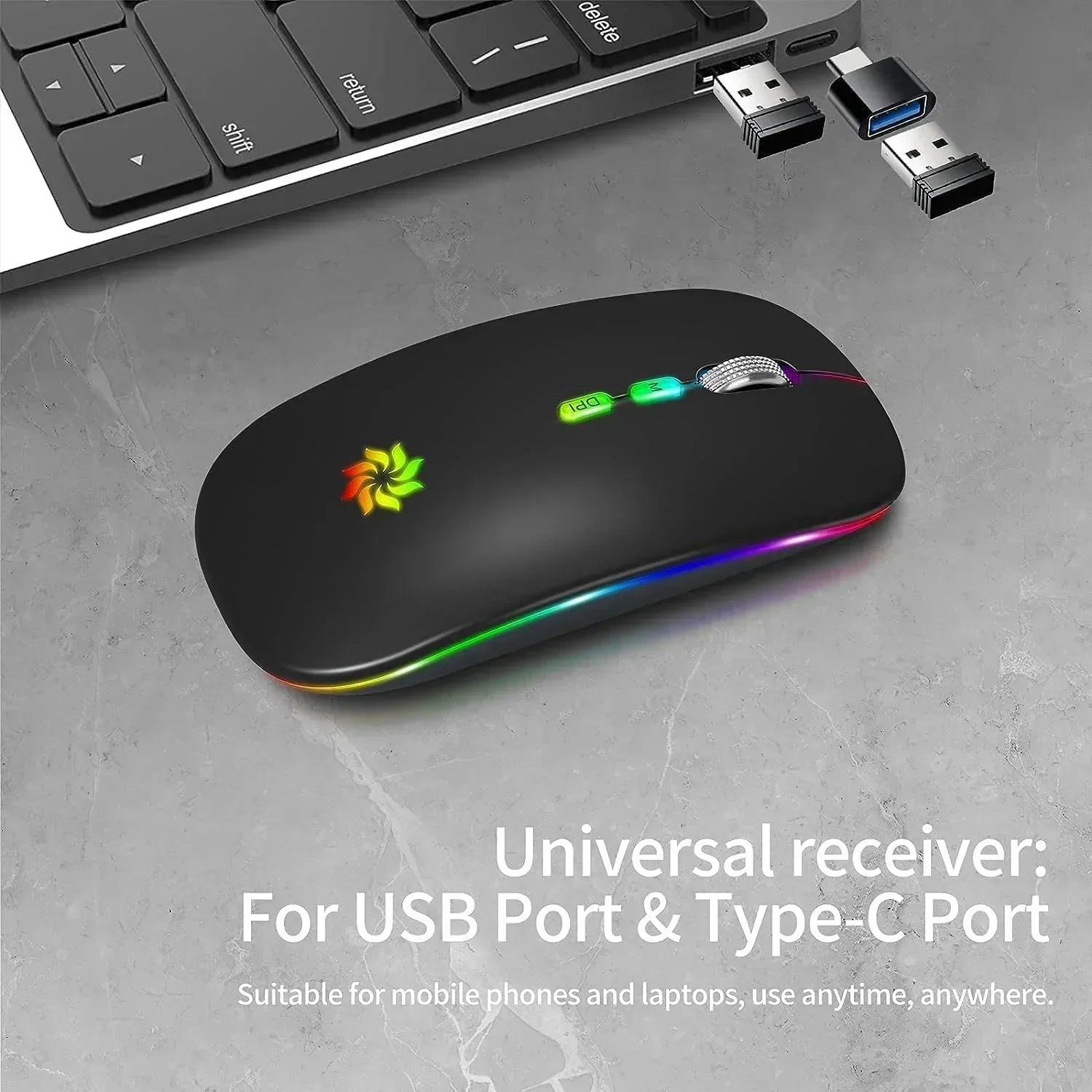 Wireless RGB gaming mouse with USB and Type-C receiver next to a laptop on a gray surface