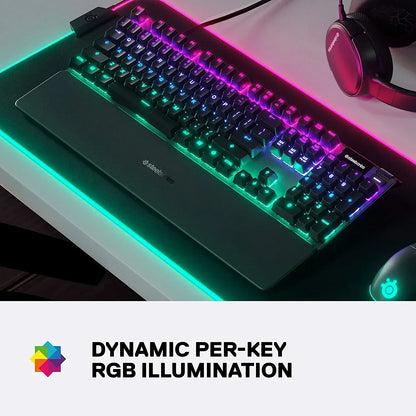 RGB gaming keyboard and mouse on desk with SteelSeries headset, dynamic per-key illumination