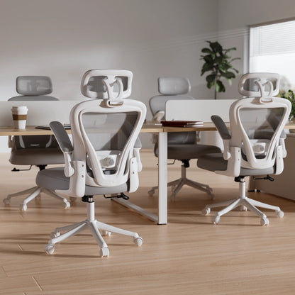 White ergonomic office chairs with mesh backrests at modern desks in bright workspace