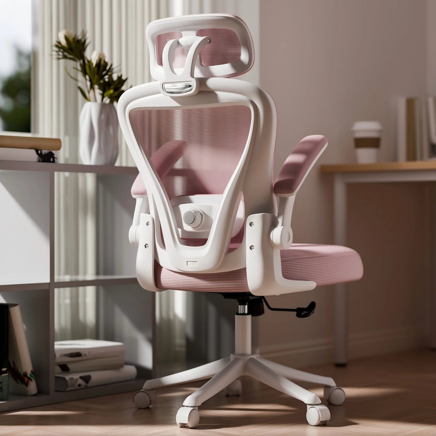 White and pink ergonomic office chair with mesh back, headrest, and adjustable arms in modern home setup