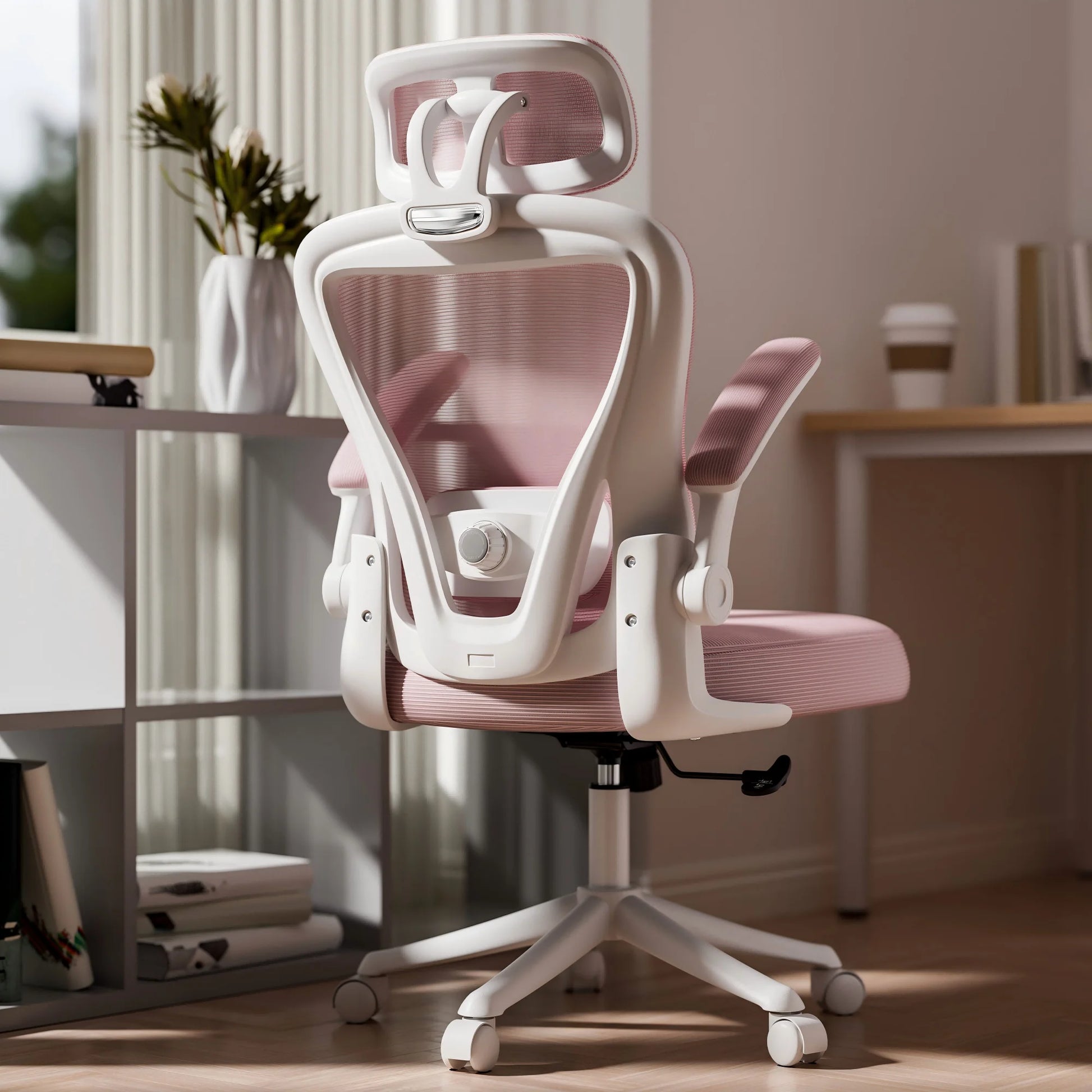 White and pink ergonomic office chair with mesh back, headrest, and adjustable arms in modern home setup