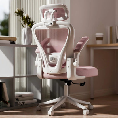 White and pink ergonomic gaming chair with mesh back, headrest, and adjustable arms in home office setup