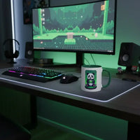 Gaming setup with widescreen monitor, RGB keyboard, mouse, and a panda-themed mug on desk