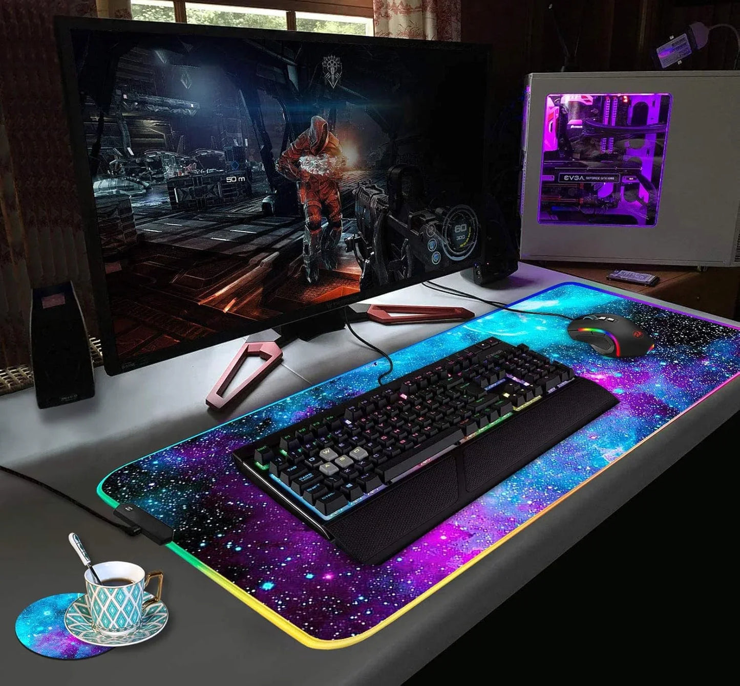 Gaming setup with widescreen monitor showing sci-fi shooter, RGB keyboard and mouse on galaxy-themed mouse pad, and white PC tower with purple LED lighting