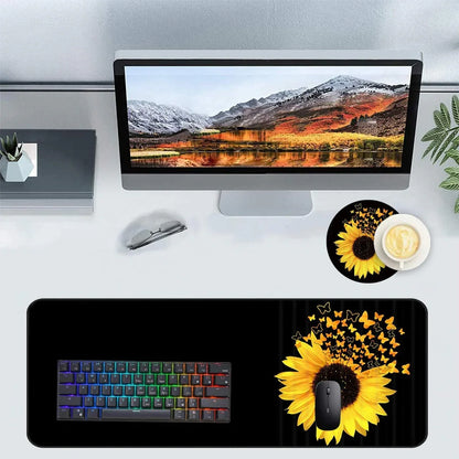 Modern desktop setup with curved monitor displaying mountain landscape, RGB backlit keyboard, sunflower and butterfly gaming mouse pad, sunglasses, and coffee cup on white desk