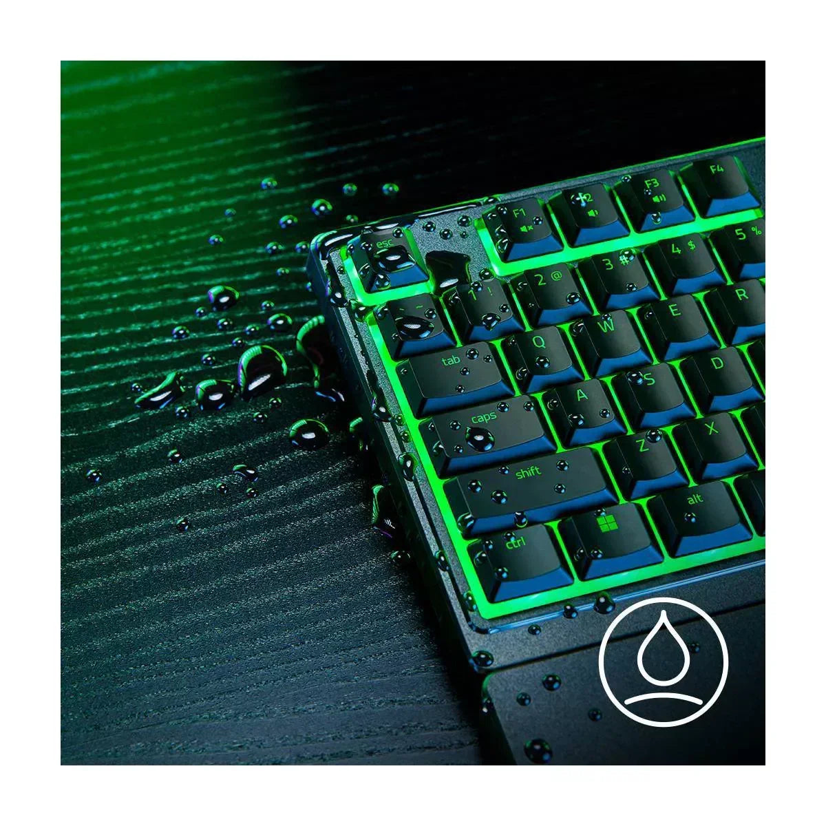RGB gaming keyboard with water droplets, showing water resistance on black desk