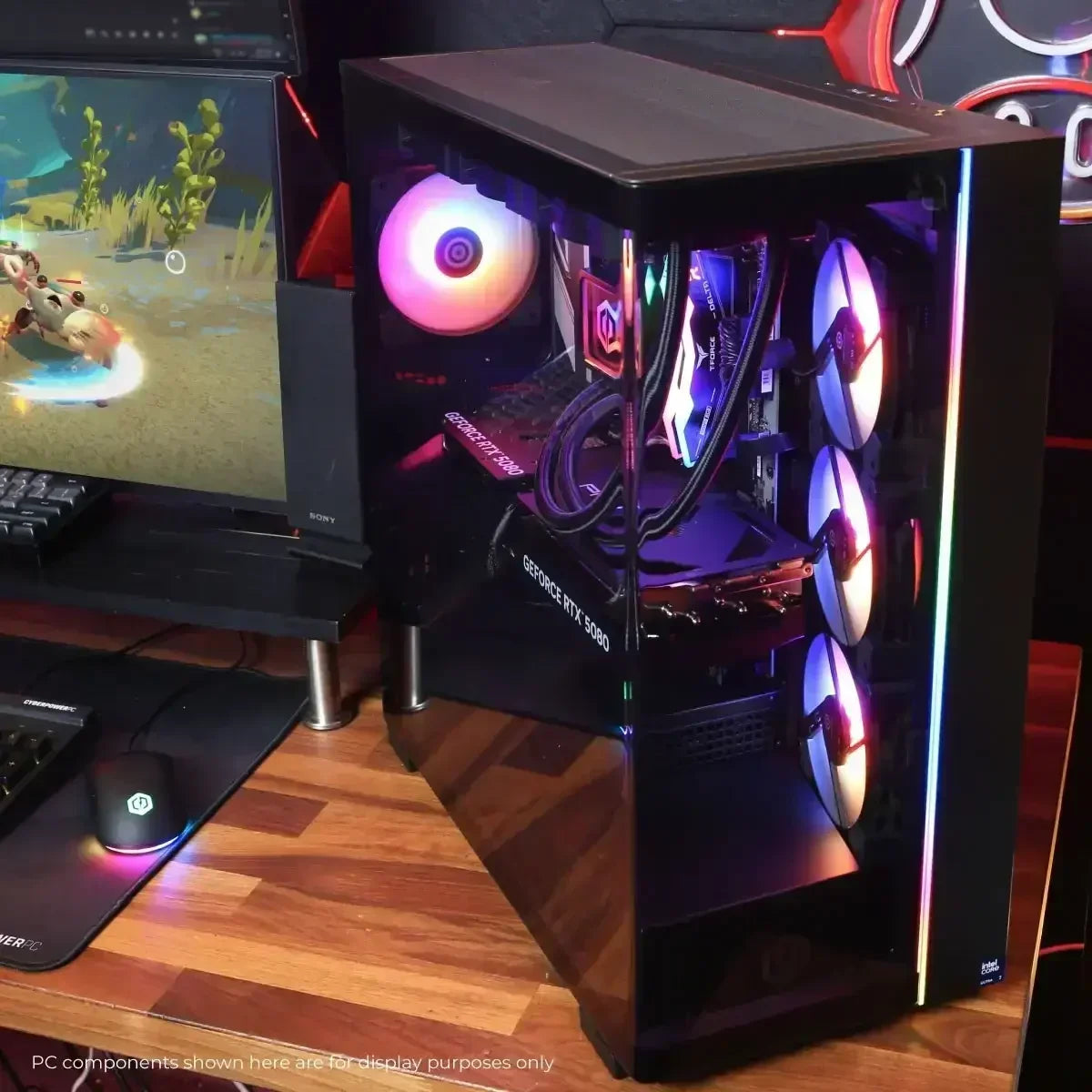 Gaming PC setup with RGB-lit desktop tower featuring GeForce RTX 5080 GPU and three front cooling fans