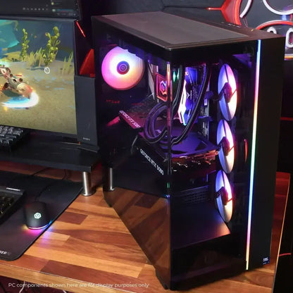 Gaming PC setup with RGB-lit desktop tower featuring GeForce RTX 5080 GPU and three front cooling fans