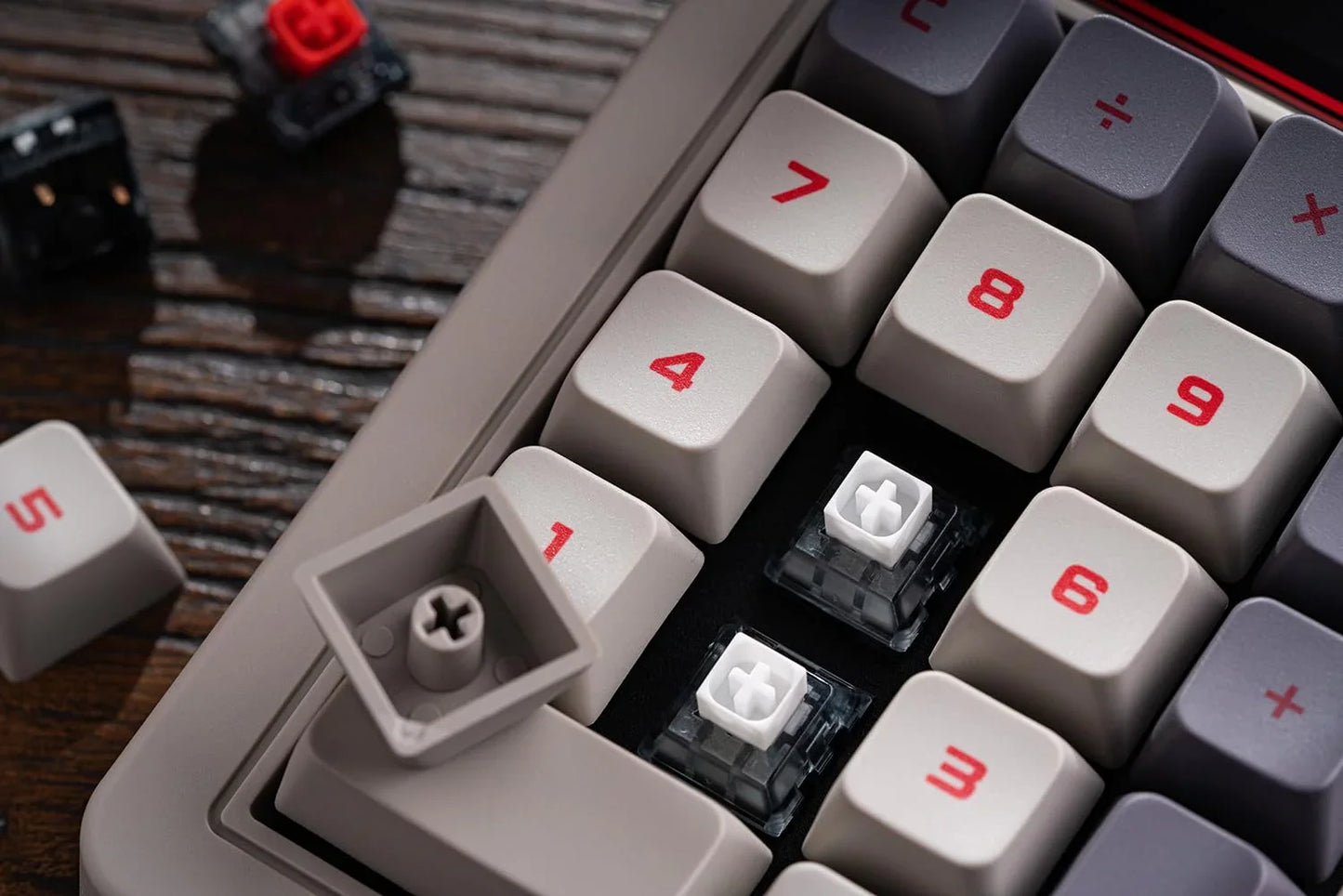 Close-up of a mechanical keyboard with keycaps removed, exposing white switches, retro style.