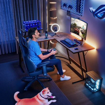 Man playing racing video game on curved monitor in modern gaming setup with RGB lighting and dog