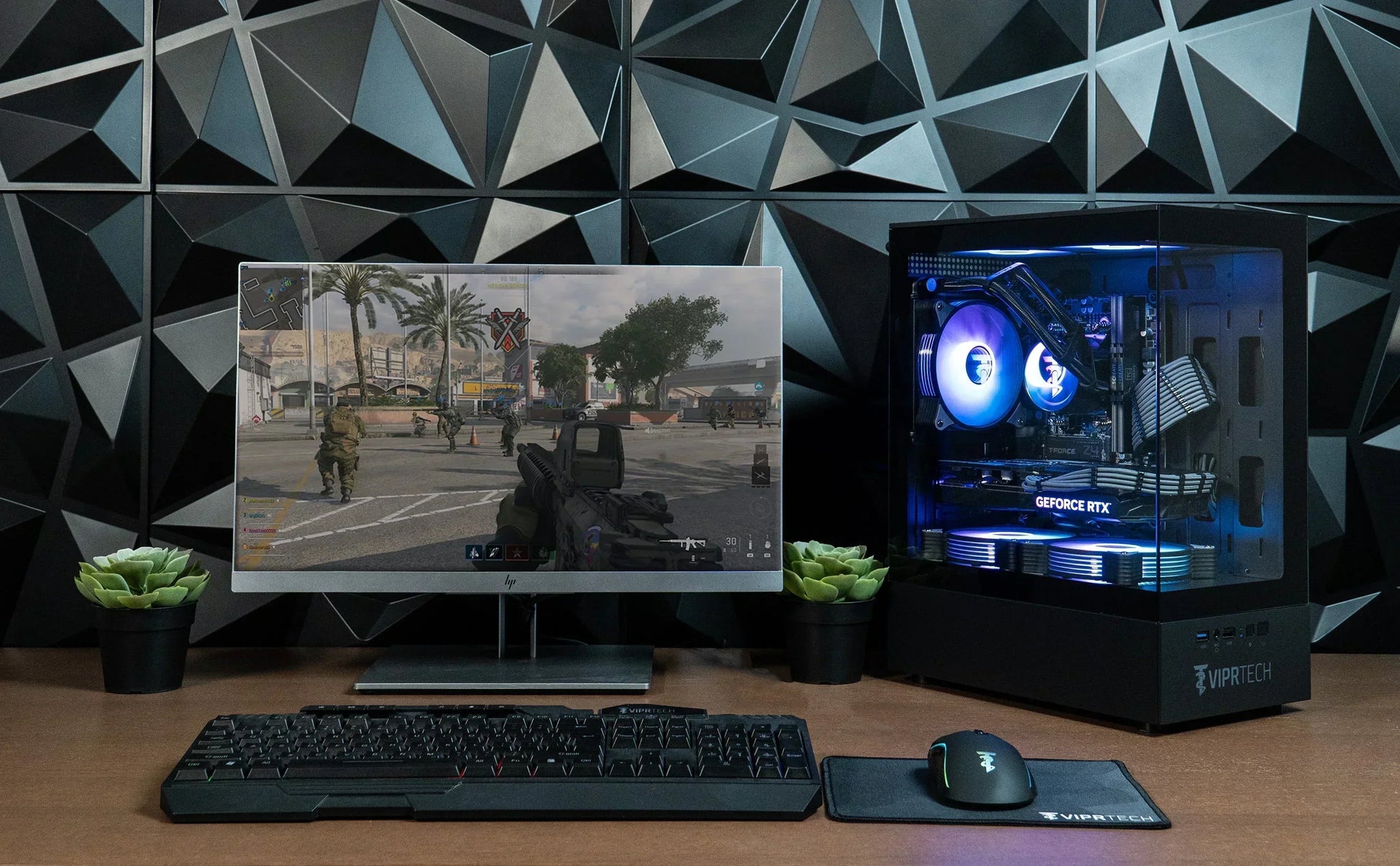 RGB gaming PC setup with monitor, mechanical keyboard, gaming mouse, and geometric wall paneling
