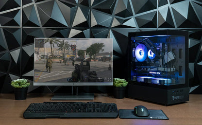 RGB gaming PC setup with monitor, mechanical keyboard, gaming mouse, and geometric wall paneling