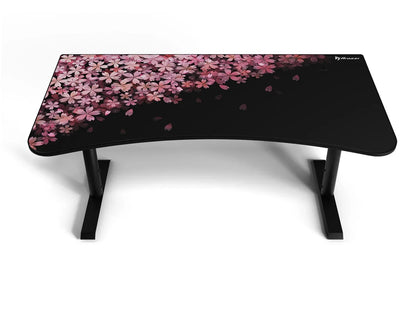 Black Arozzi gaming desk with curved surface and pink cherry blossom floral design