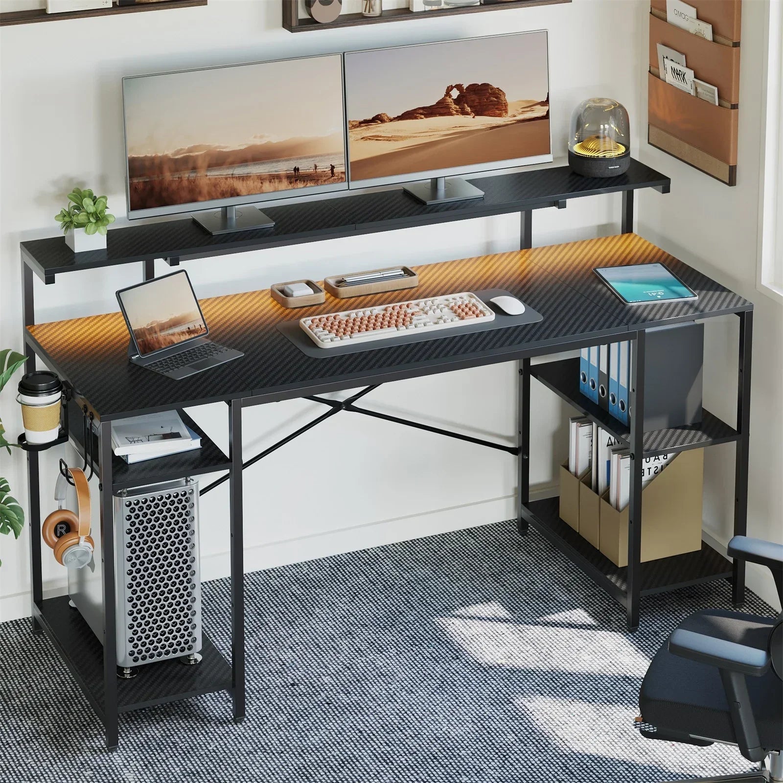Modern black carbon fiber desk with dual monitors, laptop, tablet, mechanical keyboard, and office accessories