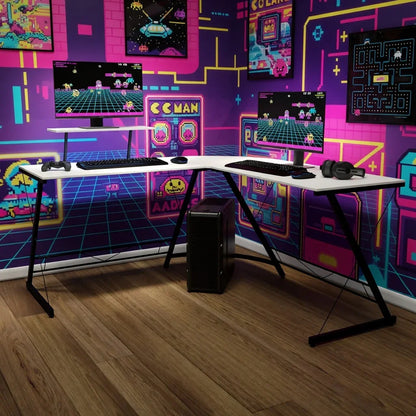 Retro gaming setup with dual monitors, keyboard, headset, and neon 8-bit arcade wall decor