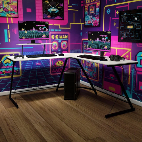 Retro gaming setup with dual monitors, keyboard, headset, and neon 8-bit arcade wall decor