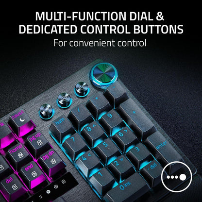 RGB mechanical gaming keyboard with multi-function dial and control buttons on dark surface