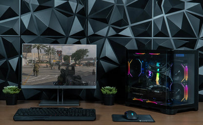 Gaming PC setup with RGB-lit device, mechanical keyboard, mouse on mat, and FPS game on monitor