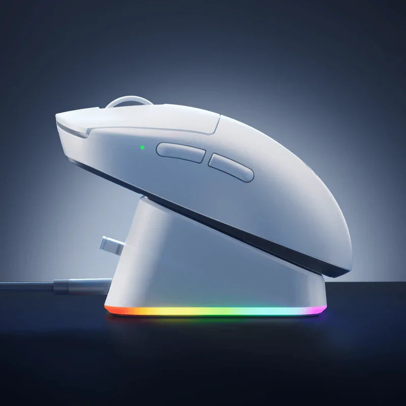 White gaming mouse with RGB lighting on charging dock, sleek ergonomic design for PC gamers