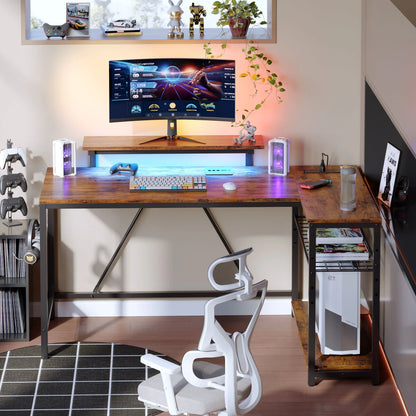 L-shaped rustic gaming desk with LED lights, curved monitor, keyboard, controllers, ergonomic chair, and gaming accessories