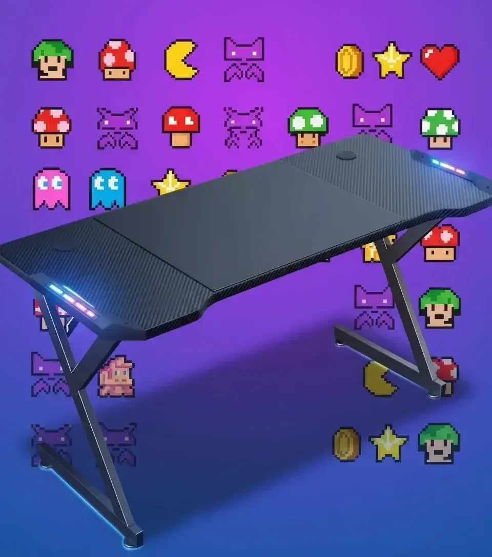 Black gaming desk with LED lights and carbon fiber texture against a purple wall with pixel art game icons
