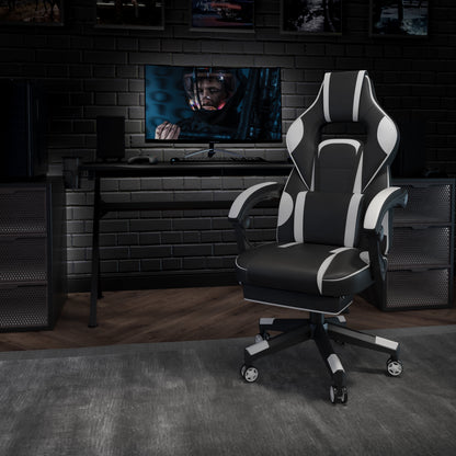 Black and white gaming chair in modern setup with monitor and desk accessories