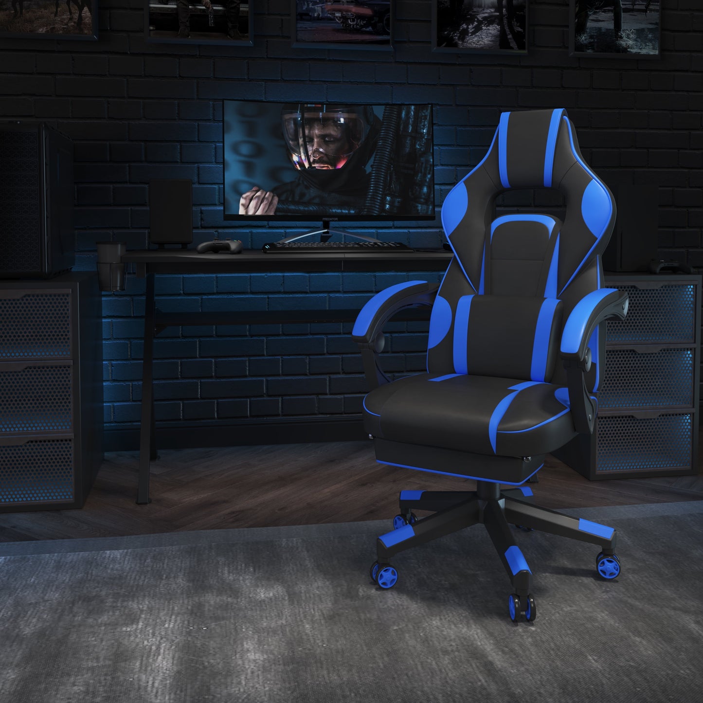 Black and blue gaming chair in a dark, modern gaming setup with desk, monitor, and PC