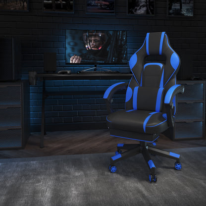 Black and blue gaming chair in a dark, modern gaming setup with desk, monitor, and PC