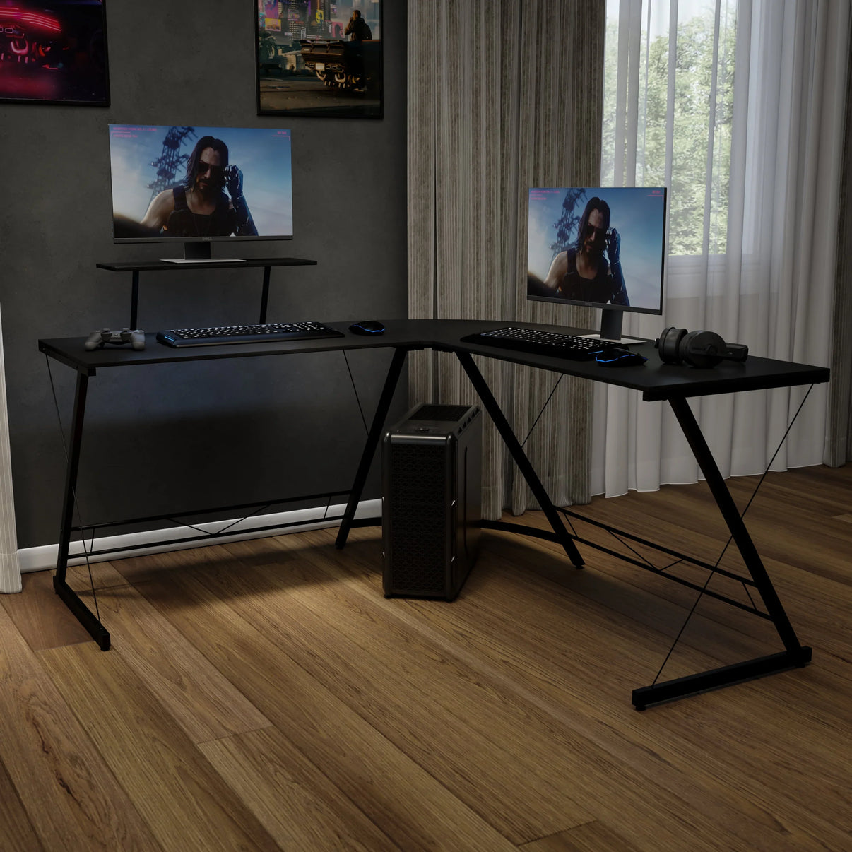 L-shaped black computer desk with gaming setup including dual monitors, keyboards, mouse, headphones, and game controller in modern room