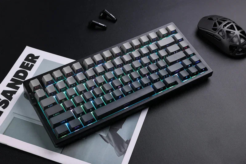 RGB mechanical gaming keyboard with sleek black design, paired with ergonomic mouse and earbuds on dark desk
