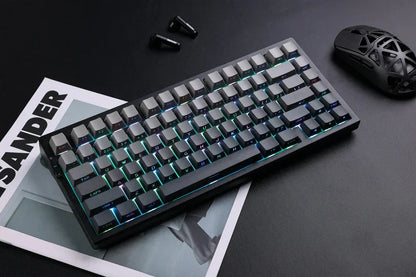 RGB mechanical gaming keyboard with sleek black design, paired with ergonomic mouse and earbuds on dark desk