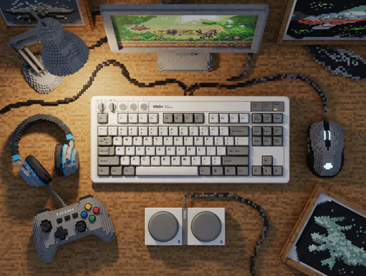 Pixel art style gaming setup with mechanical keyboard, mouse, headset, controller, and monitor