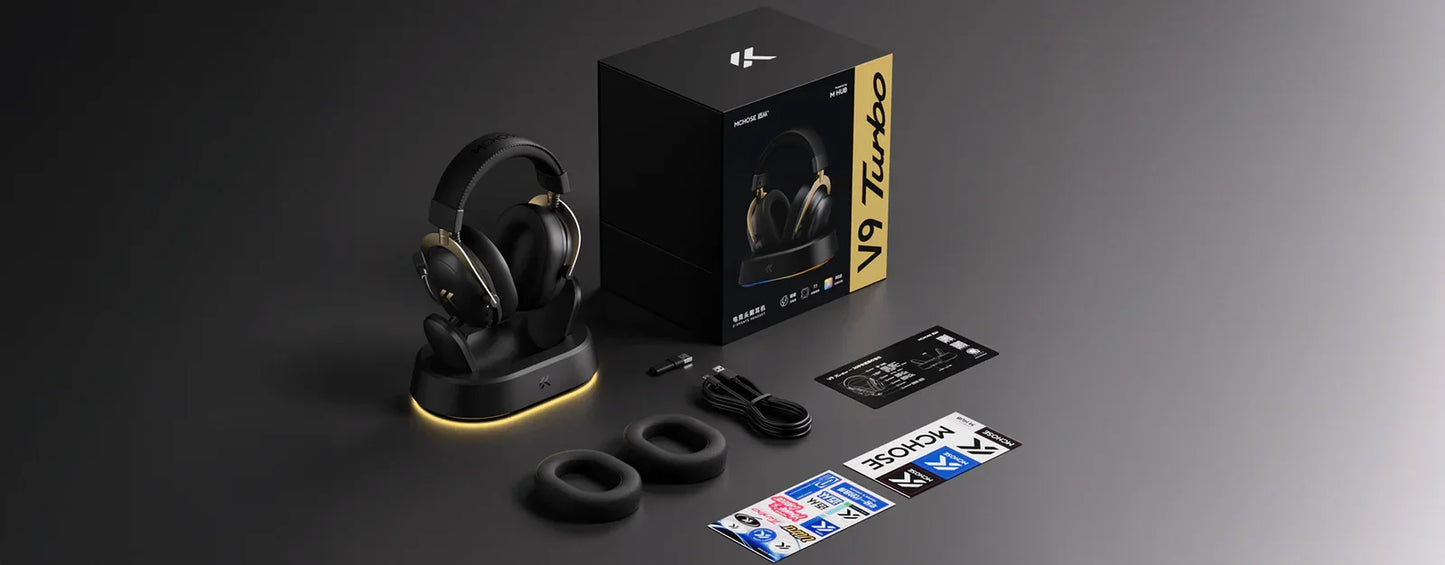 MCHOSE V9 Turbo wireless gaming headset with charging dock, ear cushions, and accessories on dark background