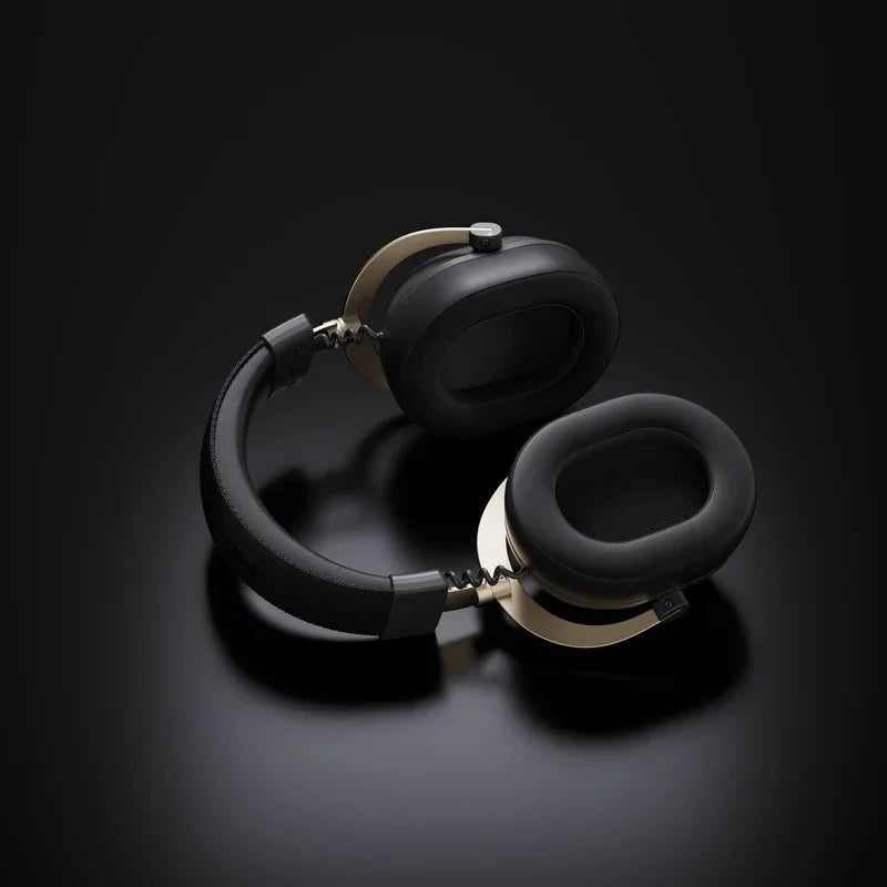 Black and gold gaming headset with plush earcups on dark background, ideal for immersive audio